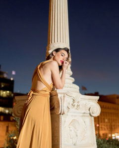 Our model in the Calypso Polymorphic Maxi Dress, in the Yellow Mustard shade from the side