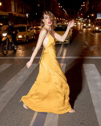 Our model in the Cecilia Tallis Slip Dress, in the Yellow Mustard shade from the side