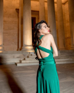 Our model in the Calypso Polymorphic Maxi Dress, in the Emerald Green shade from the side