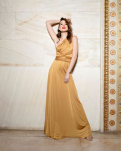 Our model in the Calypso Polymorphic Maxi Dress, in the Yellow Mustard shade from the front